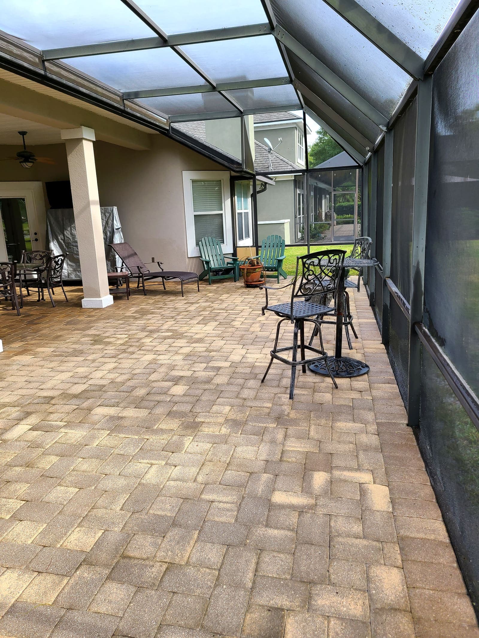 The same lanai floor cleaned, the paver color even across the whole area.