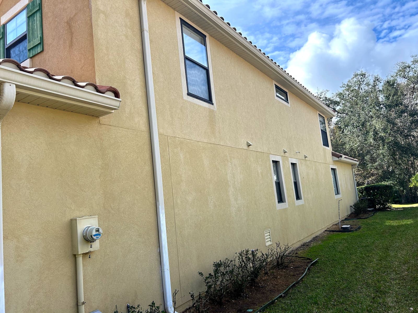 The same stucco wall washed back to an even cream color.
